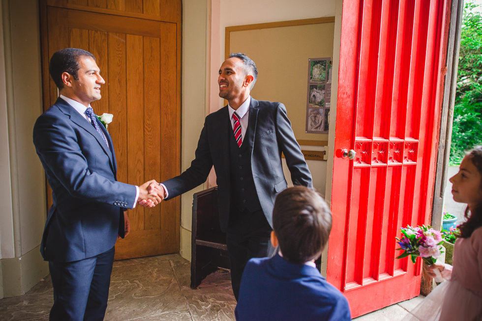 Best Man shaking hands with guests